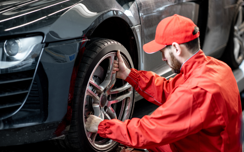 car service worker changing wheel