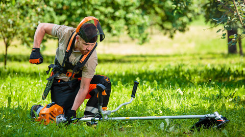 a man checking a whipper snipper engine