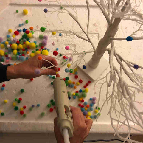 Glueing pom poms on tree