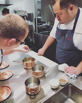 Chef Jeremy Correia at work in the kitchen perfecting a dish with a fellow chef.