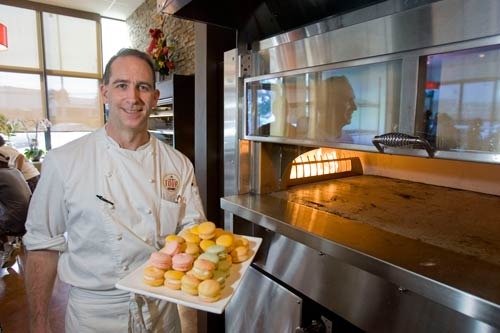 Pastry chef Rodney Weddle holding up a delicious platter of pastries.