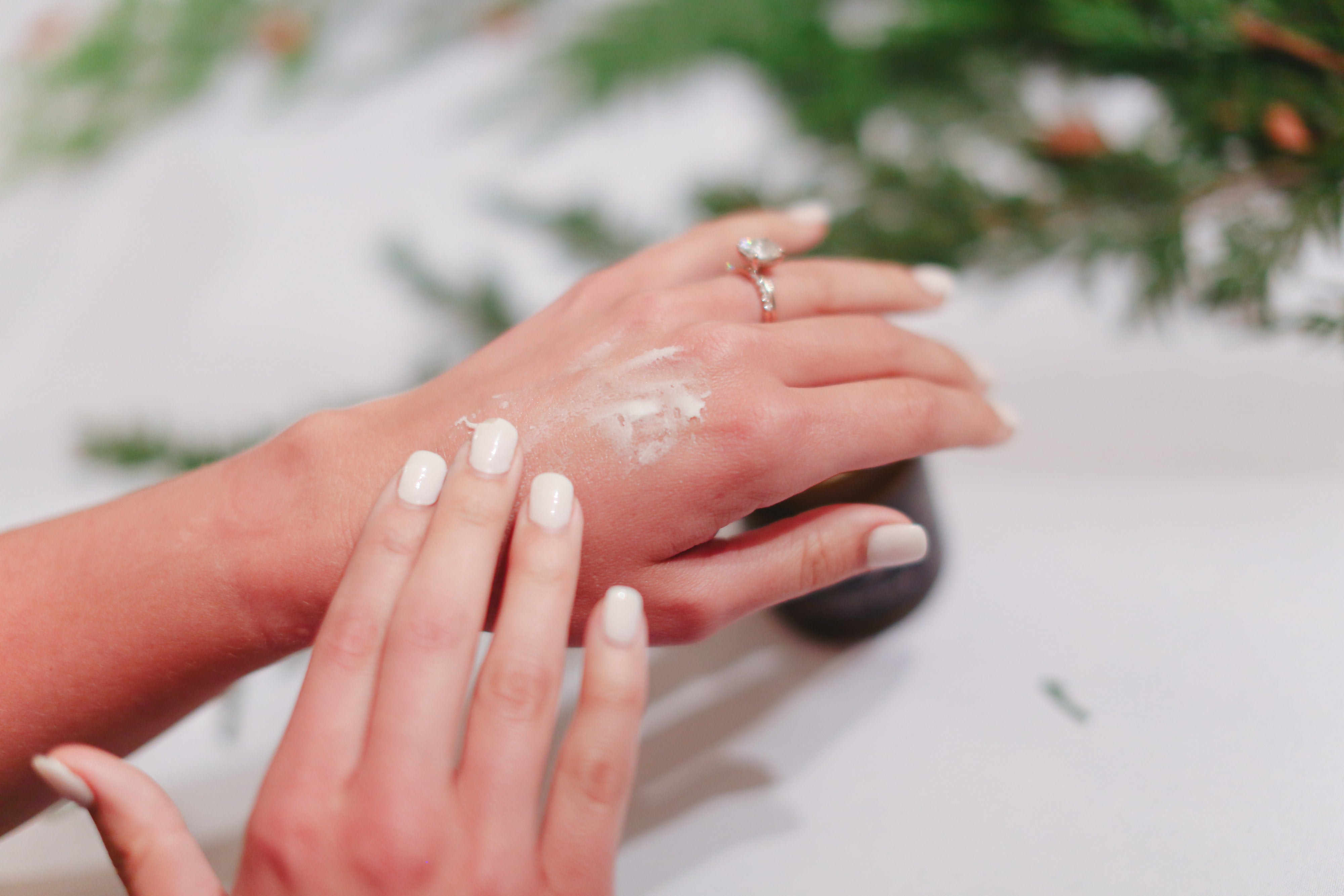 woman applying tallowbalm skincare to sensitive skin 