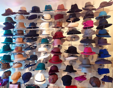 Wall showing over 70 different styles and colours of winter hats in Ella Bulloch shop