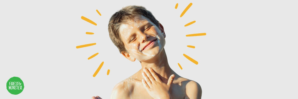 Young Boy Putting On Sunscreen