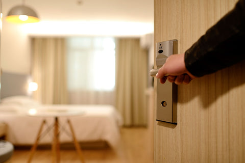 man opening a door in a hotel