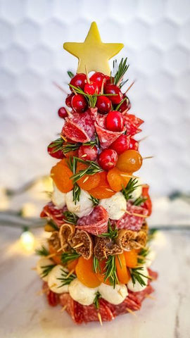 a tree with charcuterie on it for eating with friends