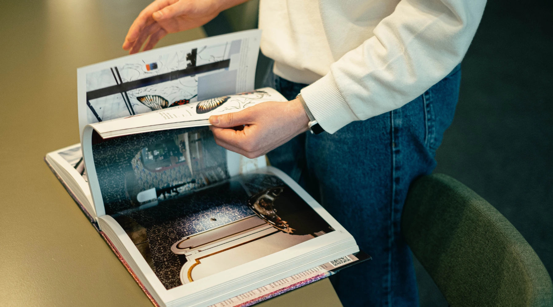 men looking at an interior design magazine