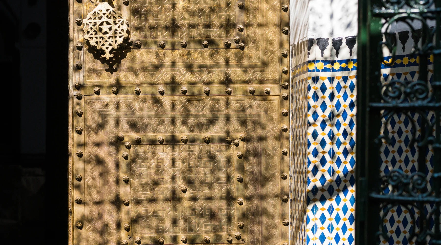 Intricate geometric pattern of moroccan zellige on traditional brass door
