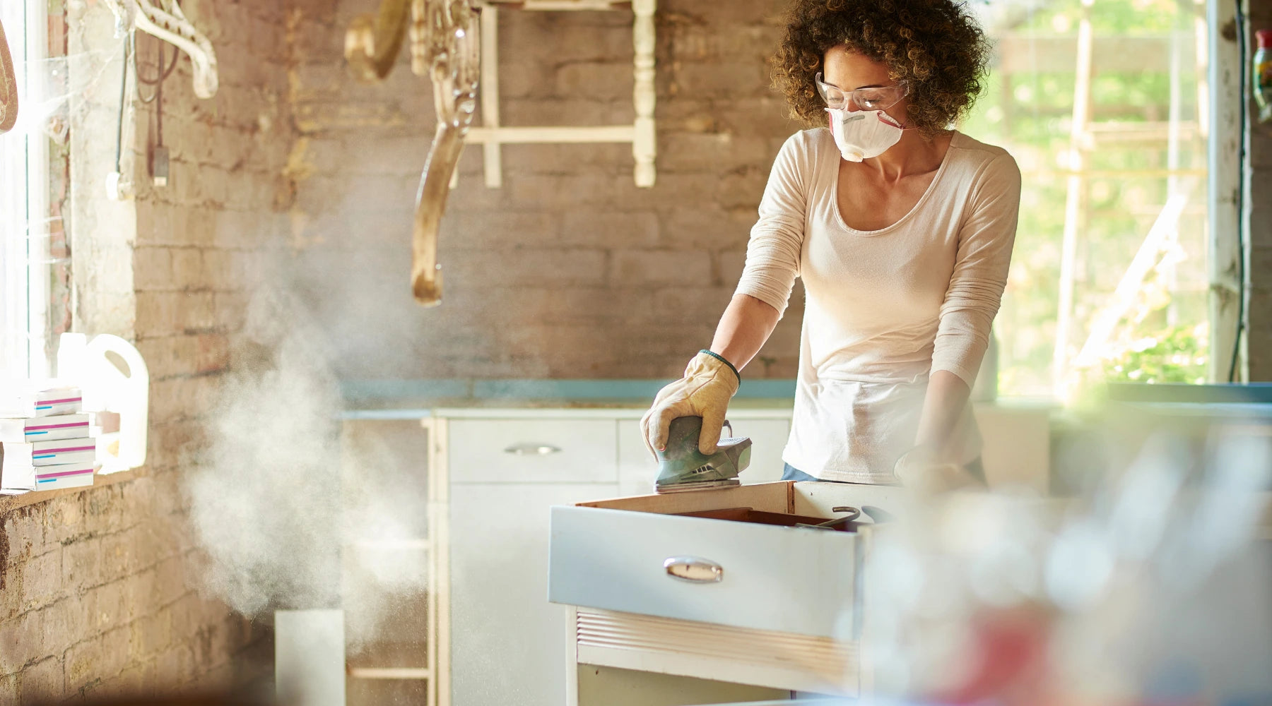 women doing diy sanding old furniture for recycling
