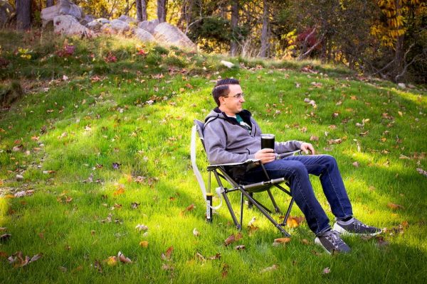 man sitting in GCI Outdoor Kickback Rocker chair