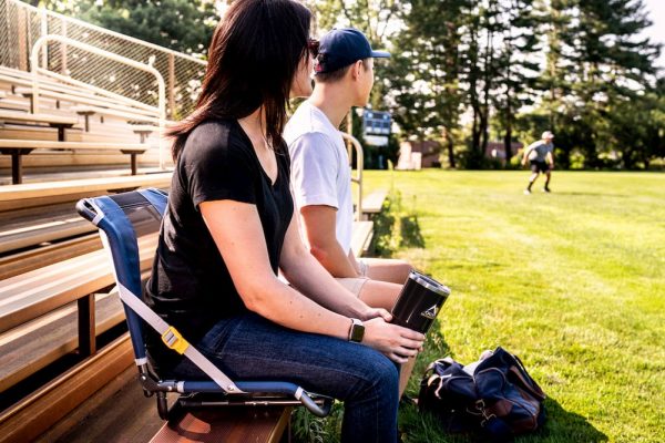 woman sitting in GCI Outdoor Stadium Chair while watching game