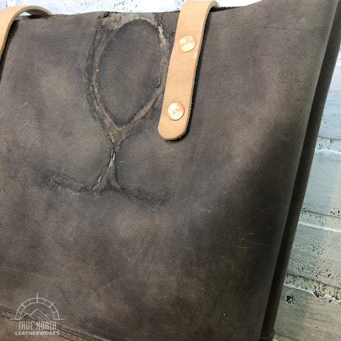 leather tote with brand in the leather