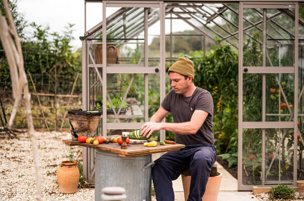 Gill Meller chopping freshly picked greenhouse crops for alfresco cooking over a dustbin firepit BBQ