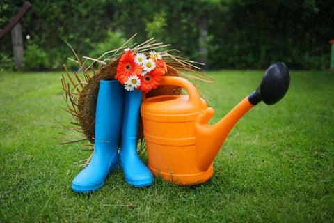 Orange watering can and  blue wellies