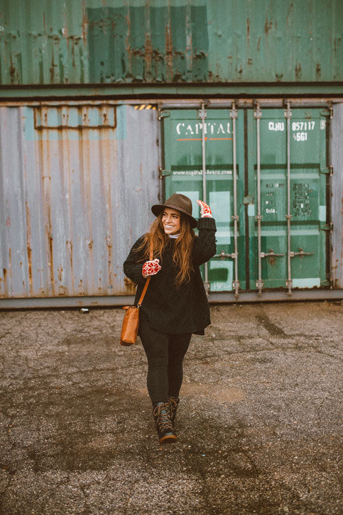 Influencer wearing black sweater, jeans, looking off to the side walking outside wearing Cougar Original Pillow Boot in Black