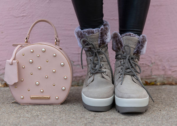Krystin Lee feet Vanetta Suede Mid Boot in Mushroom and pink purse next to feet