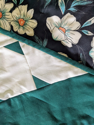 green and white floral modern quilt with black background