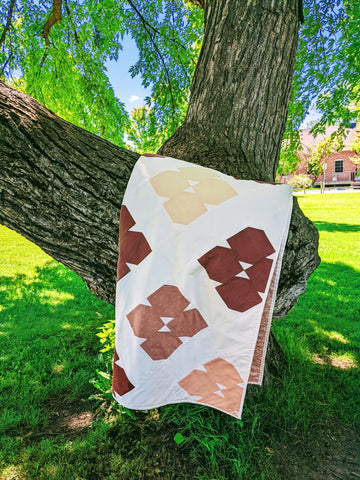 pink and white modern simple quilt on tree