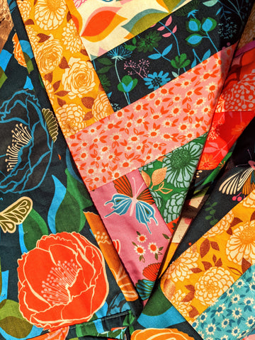 colorful floral fabric in yellow, blue, pink, orange and green