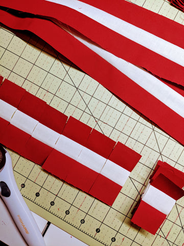 red and white strips of fabric sewn together and cut into smaller pieces