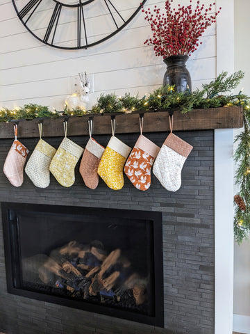 homemade yellow and orange stockings on christmas mantle