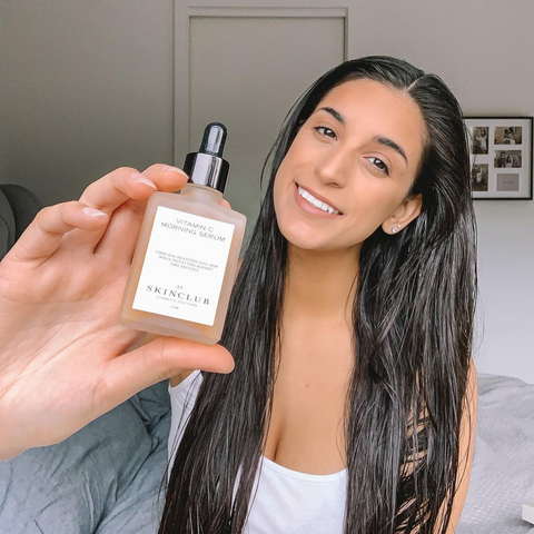 woman showing Vitamin C Morning Serum in her hand