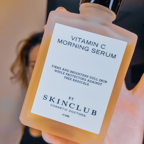 woman showing Vitamin C Morning Serum in her hand