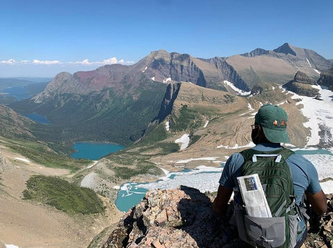 Man sitting with back to camera staring at mountains - Travel Love TraveLover TraveLoveGo