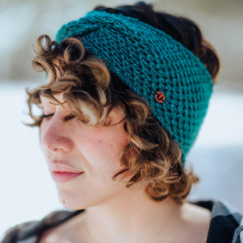 woman wearing teal luna twist headband lightweight beanie