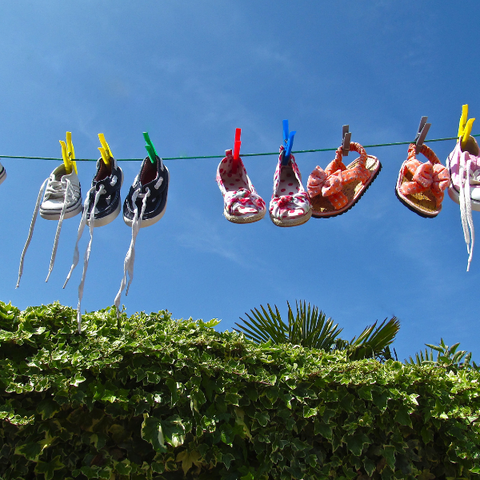 Shoes hanging to dry on a washing line outside