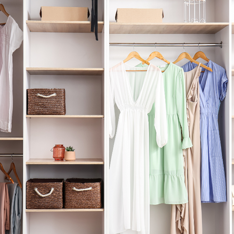 The interior of a wardrobe with hanging summer dresses