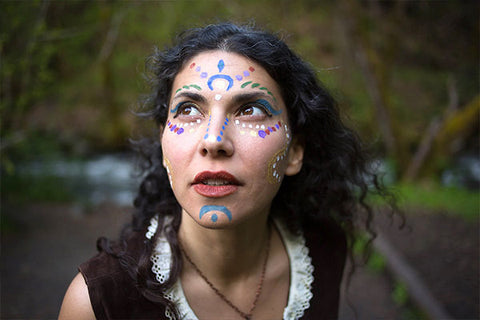 Close-up of a woman's face featuring intricate face painting for kids designs