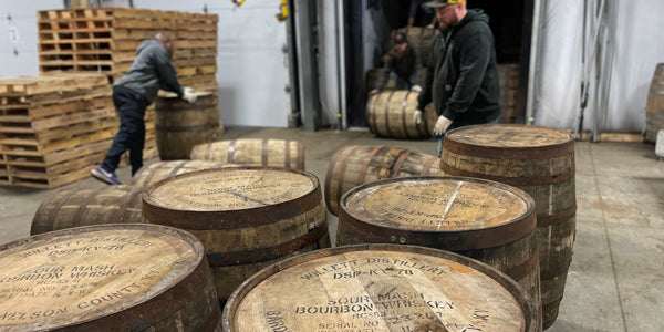 Barrel team members unloading a truckload of barrels from Willett Distillery.