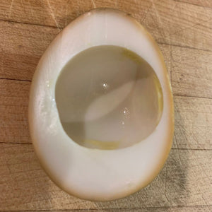 Egg that has had yoke removed from center after being hardboiled.