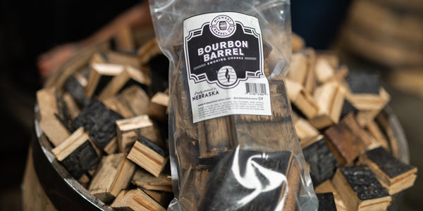 Bag of Bourbon Barrel BBQ Smoking Wood chunks sitting on top of pile of chunks
