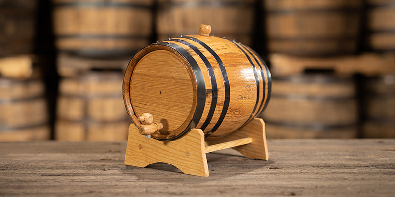 Small liter oak aging barrel on a stand