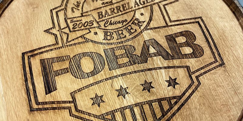 Head of a bourbon barrel with FOBAB (The Festival of Wood Barrel-Aged Beer) logo engraved on the head