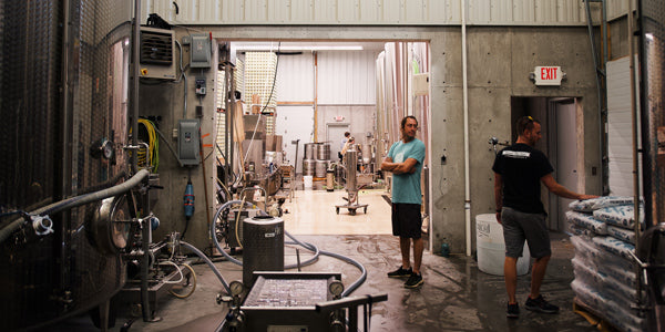 Employees working in Glacial Till's cider production facility