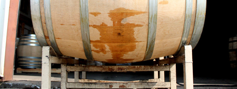 Barrel sitting on a steel rack in a warehouse