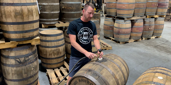 Barrel Ben uses a custom bung with pressure gauge to check pressure on a used brandy barrel.