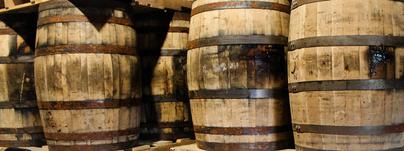 Whiskey barrels stacked on pallets in warehouse