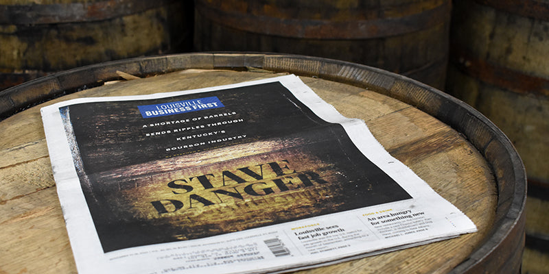 Copy of Louisville Business First newspaper with Stave Danger cover story laying on a barrel