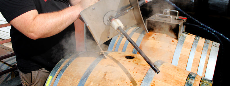 Person steaming wine barrels to swell them