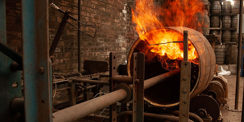 Flames char the inside of a barrel that will be used to age whiskey or bourbon.