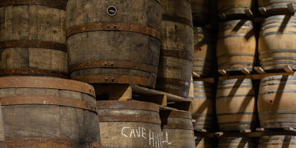 Whiskey barrels stacked on pallets in a warehouse
