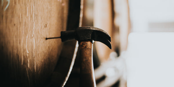 Hammer hitting a Vinnie hole into a barrel for later sampling