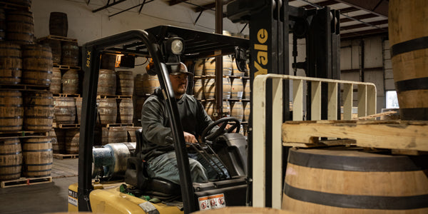 Warehouse worker operating a forklift at Midwest Barrel Co.