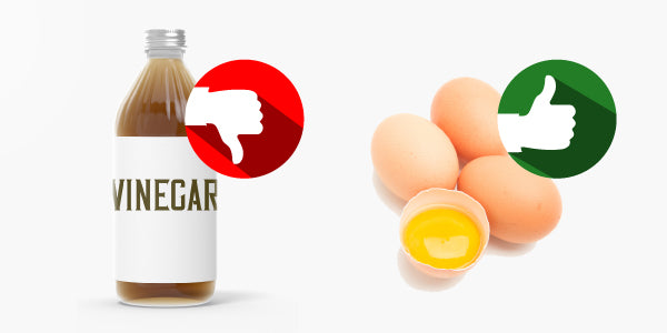 Bottle of vinegar with thumbs down image over it and four eggs, one sliced open, with thumbs up image over them.