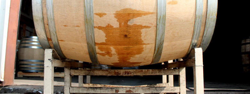 Barrel sitting on a rack in a brewery production area