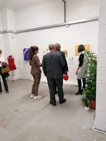 Rachel Anderson showing visitors around the exhibition